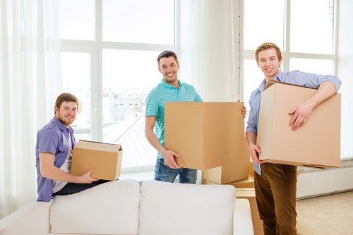 Workers carrying out careful manual handling during relocation
